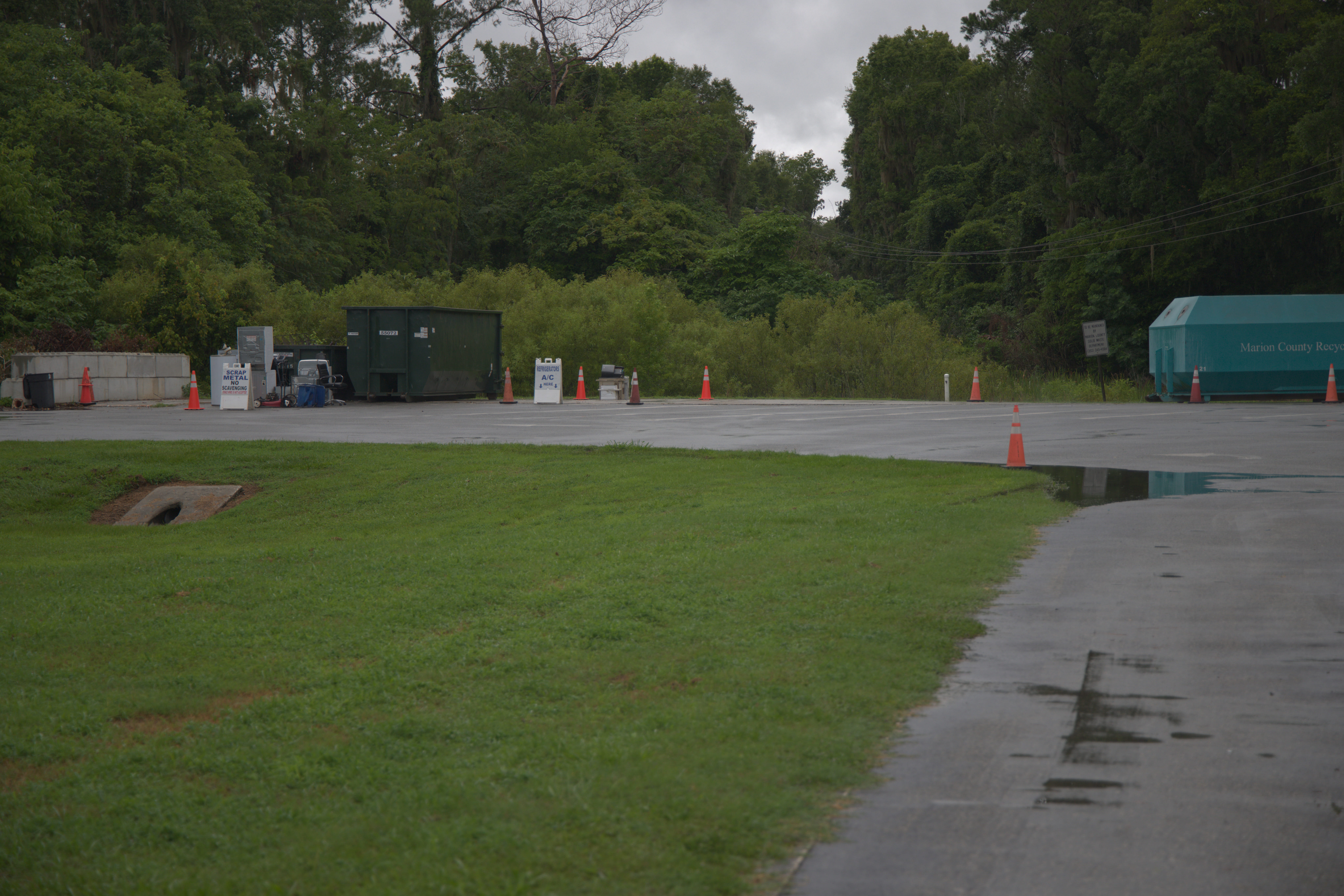 An image of a waste disposal plant, with a large amount of healthy greenery.